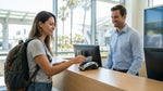 Customer handing a credit card to an agent at a car hire desk in Los Angeles