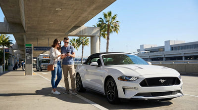 A traveler with a suitcase walks towards their car hire at the Los Angeles International Airport