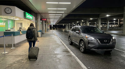 A well-lit car rental area in an Orlando airport parking garage at night, with rows of clean vehicles
