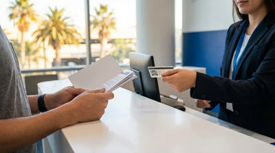 A person driving a car hire convertible along the sunny, winding coastal roads of Big Sur, California