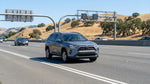 A car hire driving in traffic on the US-101 freeway with the San Francisco skyline in the background