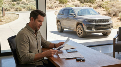 A modern car rental driving on a wide, open highway under a big Texas sky