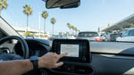 A driver inspects the interior of their car rental at a sunny pick-up location in Los Angeles