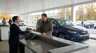 A person presenting a credit card to an agent at a car hire desk in Pennsylvania
