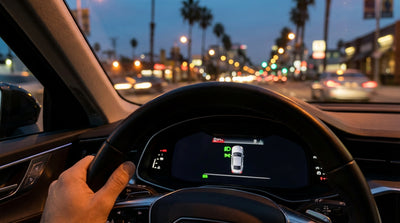 View from inside a car hire driving on a Los Angeles freeway at night with traffic lights glowing ahead