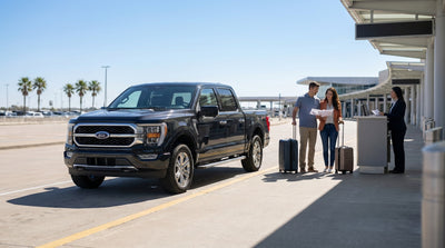 A modern car hire vehicle driving down a scenic highway in the Texas hill country on a sunny day