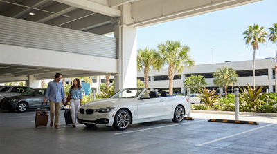 Rows of clean vehicles waiting in the brightly lit car rental garage at Orlando Airport's Terminal C