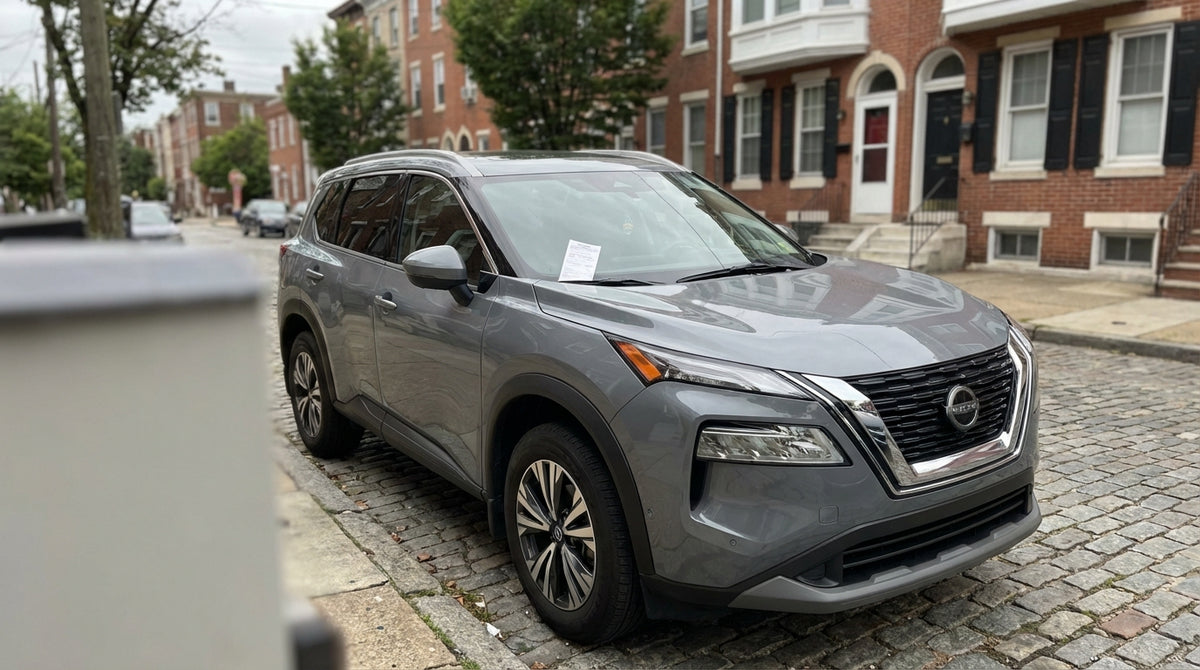 A Philadelphia parking ticket on the windshield of a car rental parked on a city street in Pennsylvania