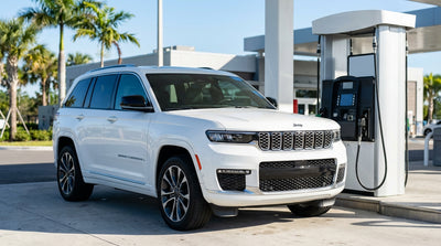 A silver car hire refueling at a gas station at a sunny Florida Turnpike service plaza