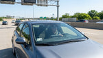 A car hire drives toward the Philadelphia skyline over a bridge with toll gantries visible in Pennsylvania