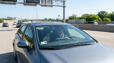 A car hire drives toward the Philadelphia skyline over a bridge with toll gantries visible in Pennsylvania