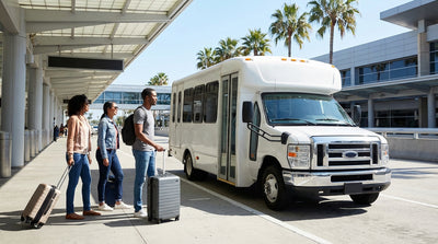 A purple car rental shuttle bus picks up travelers at a terminal in the Los Angeles airport