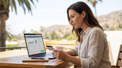 A convertible car hire driving along a sunny, winding coastal road in California