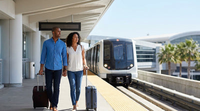 Travelers with rolling luggage walking toward the car rental desks at Miami Airport