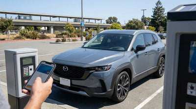 A modern car hire parked in a BART station lot with the San Francisco hills in the background