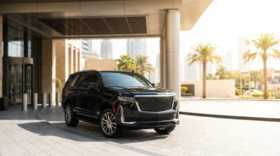 A premium SUV car hire parked on the Las Vegas Strip at night, illuminated by the vibrant lights of nearby casinos