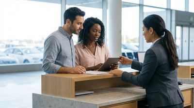 A modern car hire driving along a scenic coastal highway in the United Estates at sunset
