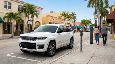 A classic car hire parked on a sunny street in Little Havana, Miami with colorful buildings and murals