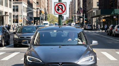A car rental driving on a busy Manhattan street in New York City with traffic and street signs