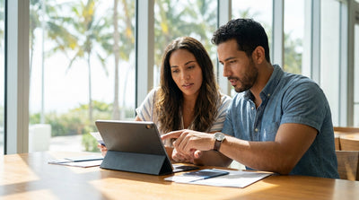 A red convertible car rental driving down a sun-drenched road lined with tall palm trees in Miami