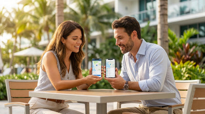 A person on a smartphone comparing car rental options with a convertible parked on a sunny street in Miami