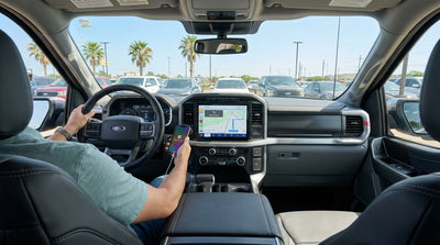 A driver's view of an Apple CarPlay map on the screen of a car rental dashboard for a road trip in Texas