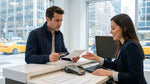 Person holding a credit card and driver's license at a car rental desk in New York