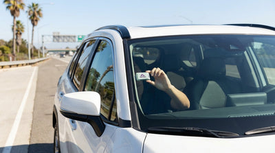 A car hire driving on a sunny California freeway with the Golden Gate Bridge in the background
