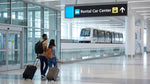 The SFO AirTrain arriving at the car rental center station in San Francisco with travelers on the platform