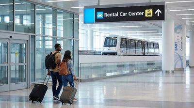 The SFO AirTrain arriving at the car rental center station in San Francisco with travelers on the platform