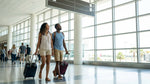 Travelers boarding a car hire shuttle bus outside Terminal E at Miami Airport