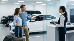 Customer handing a credit card to an agent at a car rental counter in New York