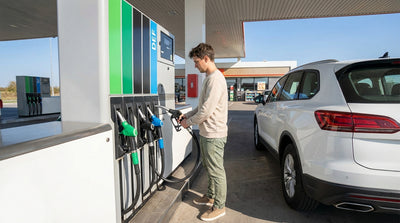 A driver at a Texas gas station choosing between petrol and diesel fuel pumps for their car hire