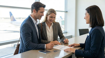 Customer showing travel documents to an agent at a car rental counter in New York
