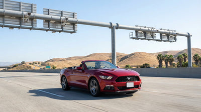 A car rental driving across the Golden Gate Bridge on a sunny day in San Francisco, California
