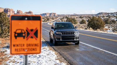 A car hire driving on a scenic desert highway leaving Las Vegas toward red rock mountains
