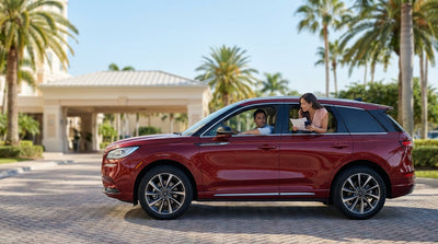 A modern white car rental parked along a scenic coastal highway with palm trees and a bright blue sky in Florida