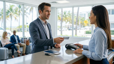 A stylish convertible car hire on a sunny street lined with palm trees in Miami