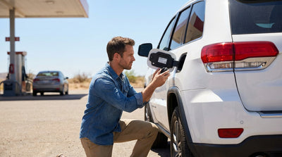 A driver refueling a modern car rental with a diesel pump at a gas station in rural Texas