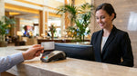 Close up of a person handing a credit card across a car rental counter in Las Vegas
