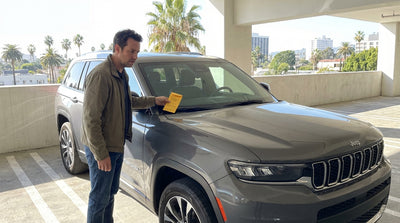 A parking ticket on the windshield of a car hire vehicle on a sunny street in Los Angeles