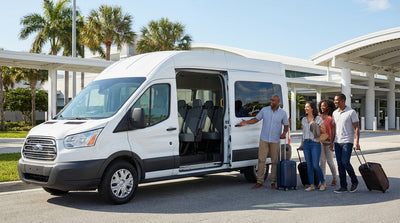 A white 12-passenger van for a car rental parked under sunny palm trees in Florida