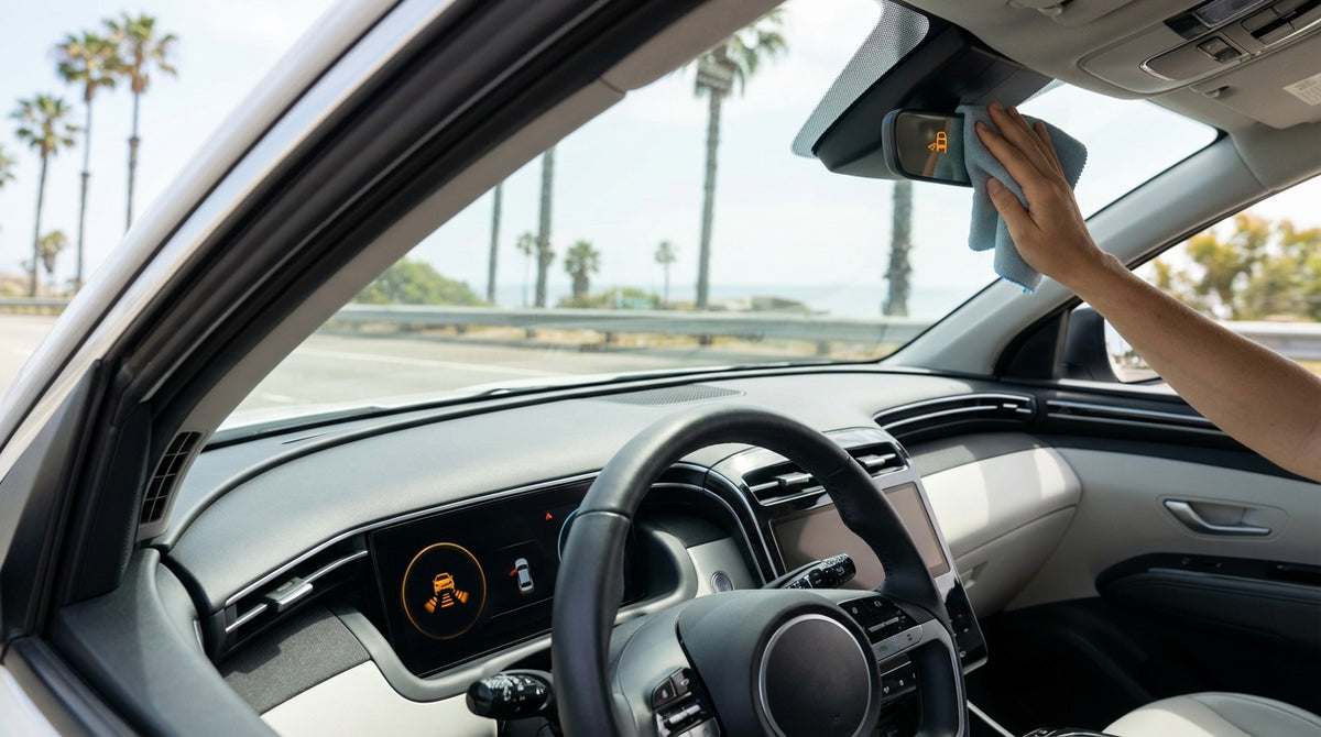 Driver's view from a car rental on a sunny California highway with a sensor warning light on the dashboard