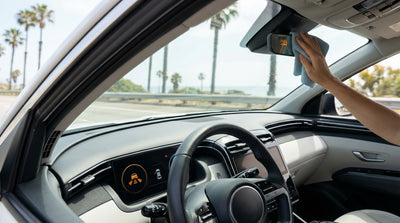 Driver's view from a car rental on a sunny California highway with a sensor warning light on the dashboard