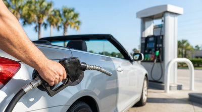 Refueling a modern car hire at a sunny gas station with palm trees in Florida