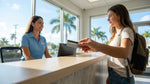 Person handing a physical credit card to an agent at a car rental desk in Miami