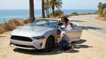 Exterior view of a car hire parked along a scenic coastal highway in California
