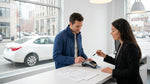 Customer handing a credit card to a clerk at a car rental desk in New York