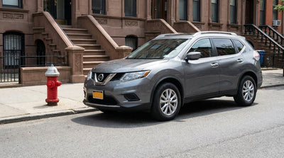 A car hire is parked on a New York street beside a red fire hydrant