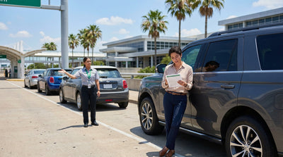 A sunny car rental lot in Texas with rows of sedans and large SUVs ready for drivers